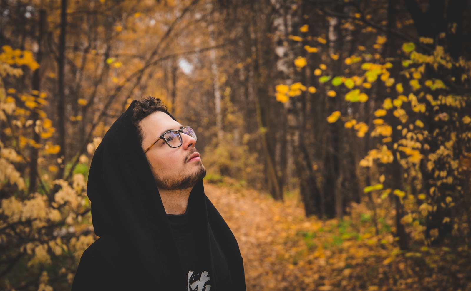 man in black hoodie wearing black framed eyeglasses